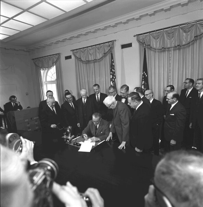President Lyndon B. Johnson signing the Constitutional Amendment on the Poll Tax.
